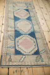 Distressed Oushak rug runner, cobalt blue and dusty pink hook and latch medallion.