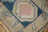 Distressed vintage Oushak runner, dusty pink central medallion with jagged cobalt blue pattern.