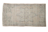 Distressed vintage Oushak rug runner, ivory field with worn aubergine and dusty blue designs.