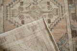 Distressed Oushak runner pile with muted geometric patterns and reverse foundation details.