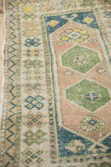 Worn pile on a vintage Oushak rug with its geometric floral and meandering zig-zag borders.