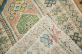 Close-up of a vintage Oushak rug's folded corner, revealing the hand-knotted foundation.