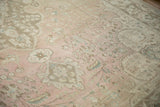 Soft texture of distressed vintage Tabriz rug, showing dusty rose field and muted floral motifs.