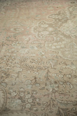 Textural detail of the vintage distressed Tabriz, showing mostly even wear and dusty rose floral motifs.