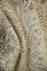 Textured pile of the distressed Tabriz carpet, showing mostly even wear and faded patterns.