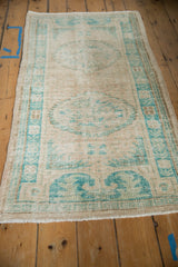 Vintage Turkish Oushak runner seen from an angle, showing its overall distressed character.