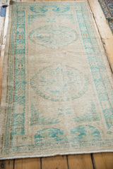 Distressed Turkish Oushak runner at an angle, showing the soft patina and low-pile texture.