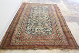Finely knotted antique Malayer runner showcasing natural-dyed deep blue field and intricate floral motifs.