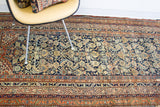 Antique Malayer rug: deep navy field, rich botanical motifs, contrasting borders, aged pile.