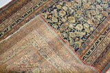 Antique Malayer rug detail, showing navy floral pile, hand-knotted reverse, patched repair, and coarser selvage.