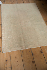 The intact side cord selvage and evenly worn pile on a vintage distressed Turkish rug.