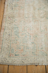 Detail showing the distressed low pile and intact side cord of a vintage Oushak.
