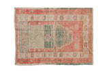 Distressed vintage Oushak rug with a prayer design in sea foam green, raspberry red, and beige.