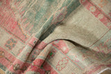 Folded vintage Oushak rug showing its distressed low-pile texture with visible knot heads.