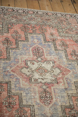 Vintage Oushak rug with distressed low pile, featuring brick red, aubergine stepped motifs.