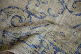 Visible merged wefts and worn knot heads detail the hand-knotted weave of this vintage Oushak carpet.