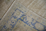 The reverse hand-knotted weave and secured side cord selvage of a vintage Oushak carpet.