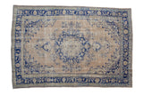 Vintage distressed Oushak carpet with a cobalt blue center medallion and great abrashes across its ivory and pale blue field.