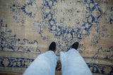 Close-up showing the distressed, even wear and low-pile texture of a vintage Turkish Oushak carpet.