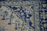 Worn, low pile texture of a vintage Oushak corner with cobalt blue stepped spandrels.