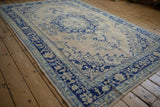 Vintage Turkish Oushak carpet showing great abrashes across its cobalt blue and ivory medallion design.