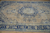 Faded blue medallion and corner spandrels on a distressed vintage Oushak rug with great abrashes.