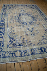 Perspective view of the distressed vintage rug's low pile, showing its cobalt and powder blue pattern.