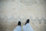 Distressed vintage Turkish Sparta rug, worn pile in ivory, beige, dusty blue underfoot.