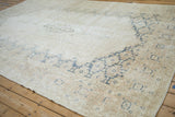 Distressed vintage Sparta rug section with faded geometric patterns in ivory and dusty denim blue.