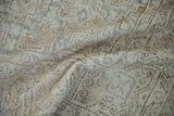 Distressed hand knotted Sparta carpet detail showing aged texture, muted beige, and faded lattice design.