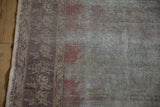 Vintage distressed Oushak rug runner detail showing worn pile, visible foundation, and intact selvage.