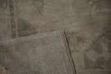Reverse view of a vintage Oushak rug highlighting its tidy, hand-knotted wool foundation.