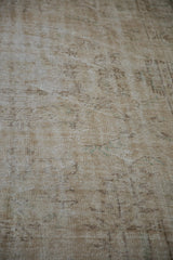 Distressed Oushak carpet pile texture with worn knot heads and exposed foundation.