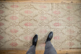Overhead view showing the scale and evenly worn texture of a distressed vintage Oushak runner.