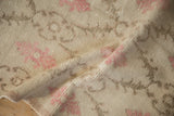 Detail of the distressed Oushak rug's texture, showing the even wear and exposed knot heads.