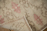 The hand-knotted back and low, even wear of a distressed Turkish Oushak rug runner.