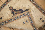 Folded vintage Oushak corner, revealing distressed pile and hand-knotted reverse side.