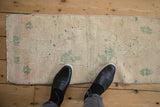 Vintage Distressed Oushak rug mat with softened ivory and seafoam green hues, showing textured patina.