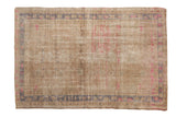 Distressed vintage Oushak rug, antique ivory with faded fuchsia and pale blue abrashes.