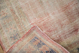 Vintage distressed Oushak rug's worn pile, exposed foundation, and pink side cord.