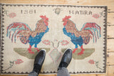 Distressed vintage Sparta rug, pictorial two roosters, germinating tree, 1981 HATIRA signature.