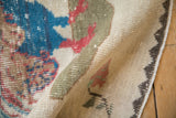 Textured close-up of distressed vintage Sparta rug pile, with light red color migration.