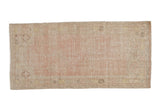 Vintage distressed Oushak rug runner featuring faded dusty rose prayer design and floral border, 2'1
