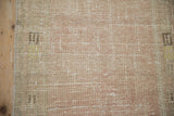 Distressed Oushak runner pile, showing wear to foundation in dusty rose and ivory.
