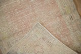 Distressed Oushak rug's worn pile texture, hand-knotted foundation, and numerical mark.