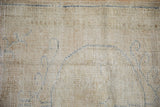 Distressed vintage Oushak rug texture: cream pile worn to reveal cobalt blue motifs.