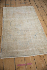 Vintage distressed Oushak runner, cream field, faded cobalt blue motifs, visible foundation.