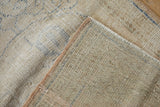 Back of vintage Oushak rug, showing cream foundation, tight knots, and side selvage.