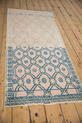 Distressed vintage Oushak runner: trellis pattern, floral motifs, pink, blue, green tones.