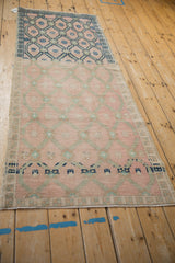 Vintage distressed Oushak runner featuring dramatic dye lot change from vibrant blue to faded pink.